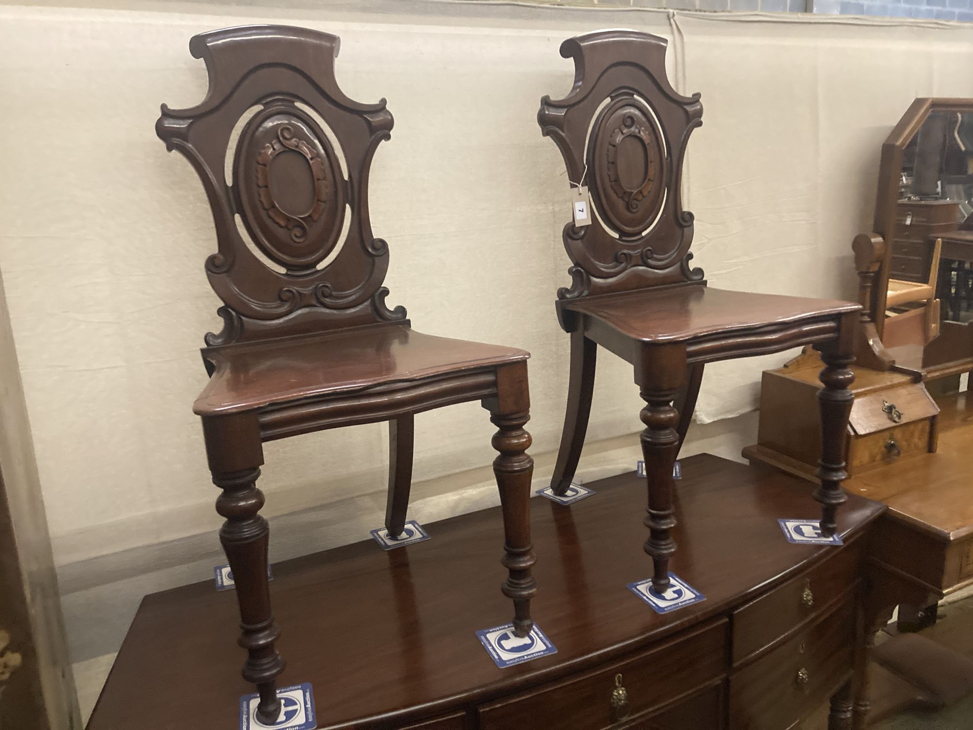 A pair of Victorian mahogany hall chairs